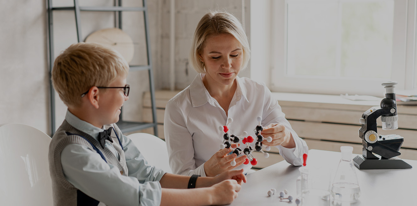 Female science tutor in Austin studying chemistry with student