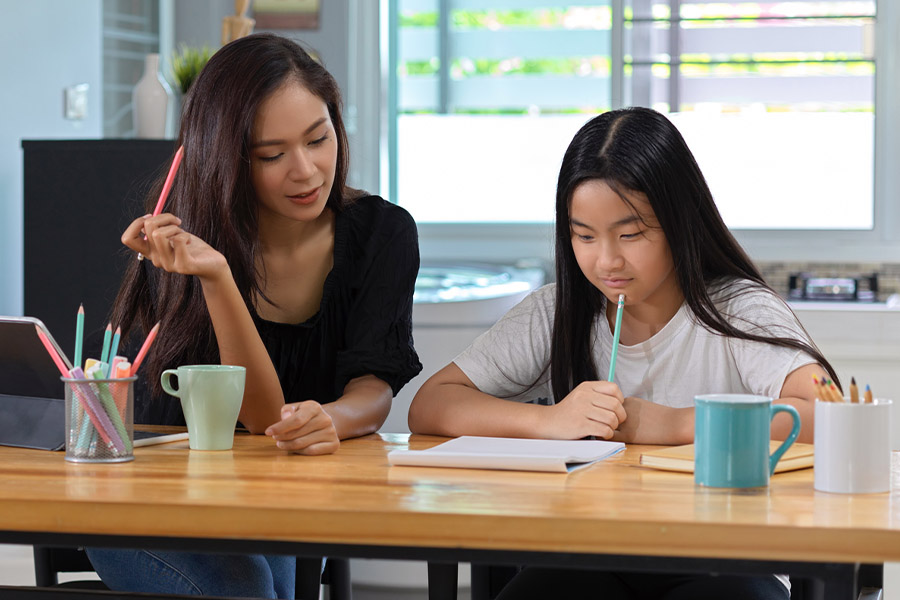 student and tutor together at a desk in Austin